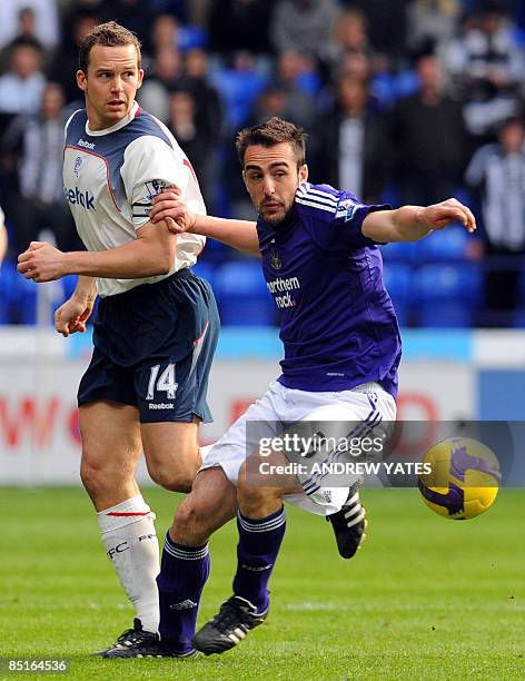 Newcastle United's Spanish defender Sanchez Jose Enrique vies with Bolton Wanderers' English forward Kevin Davies during the English Premier league...