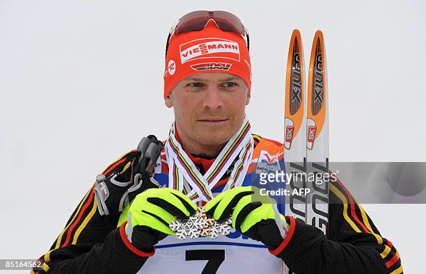 Tobias Angerer of Germany poses with his medals after the Men's 50km Mass Start Free event of the Nordic Skiing World Championships on March 1, 2009...