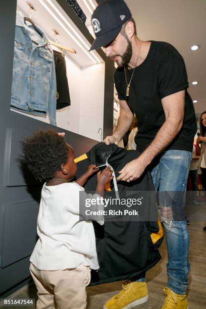 Thomas Rhett shows his daughter Willa Gray some items as Thomas Rhett kicks off his weekend Los Angeles Pop Up Store on September 22, 2017 in Los...