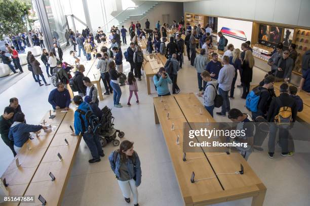 Customers view merchandise displayed during the sales launch of the Apple Inc. IPhone 8 smartphone, Apple watch series 3 device, and Apple TV 4K...