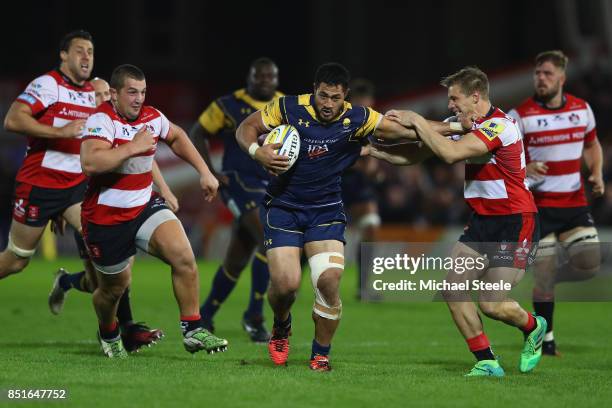 Alafoti Faosiliva of Worcester hands off Jason Woodward of Gloucester as Val Rapava Ruskin closes iduring the Aviva Premiership match between...