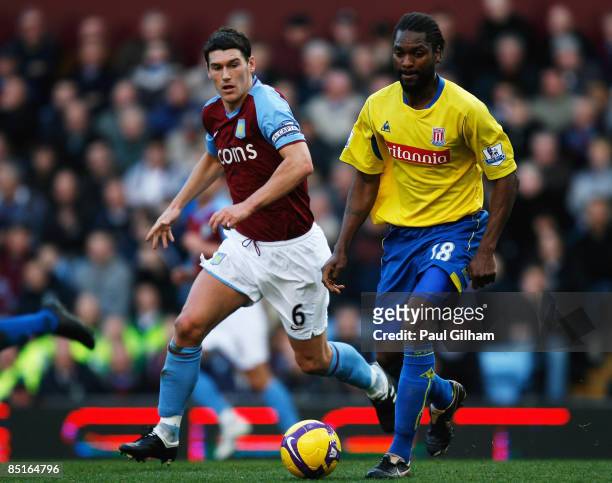 Gareth Barry of Aston Villa battles for the ball with Salif Diao of Stoke City during the Barclays Premier League match between Aston Villa and Stoke...