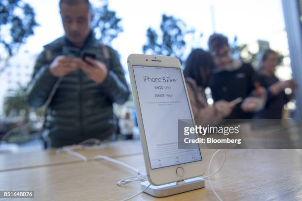 An Apple Inc. IPhone 8 smartphone stands on display during the sales launch of the Apple Inc. IPhone 8 smartphone, Apple watch series 3 device, and...