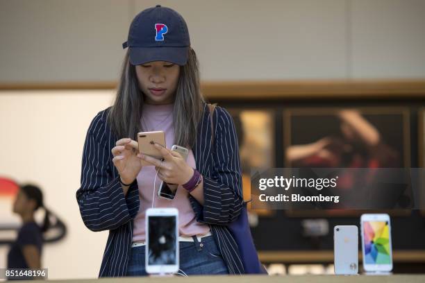 Customer views an Apple Inc. IPhone 8 smartphone during the sales launch of the Apple Inc. IPhone 8 smartphone, Apple watch series 3 device, and...