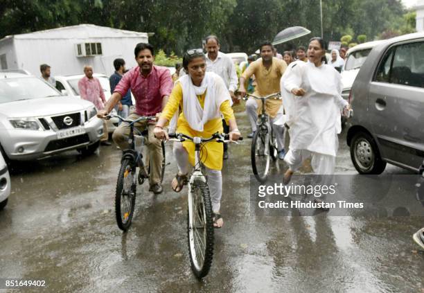 Silchar MP Sushmita Dev arrives on a bicycle to take charge of President of Mahila Congress, replacing Shobha Oza at AICC on September 22, 2017 in...