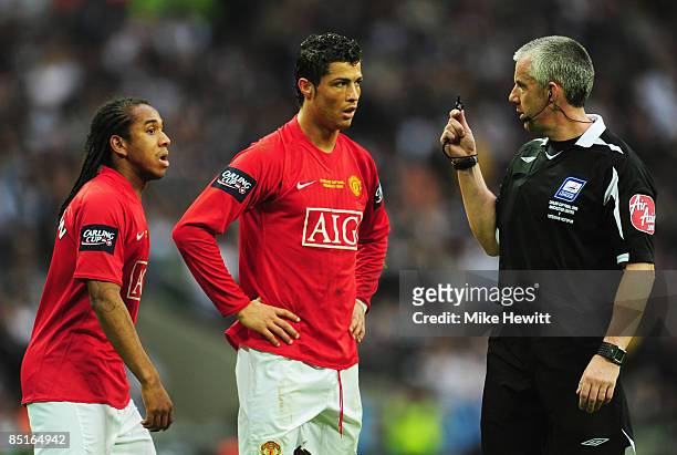 Referee Chris Foy signals to Cristiano Ronaldo and Anderson of Manchester Unitedduring the Carling Cup Final match between Manchester United and...