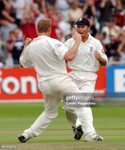 Nasser Hussain and Andrew Flintoff of England celebrate after Flintoff bowls Shaun Pollock of South Africa during the Third npower Test match between...