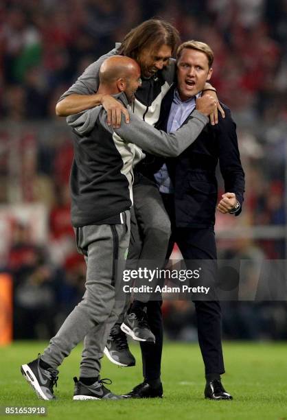 Martin Schmidt , new head coach of Wolfsburg celebrate with sport director Olaf Rebbe after the Bundesliga match between FC Bayern Muenchen and VfL...