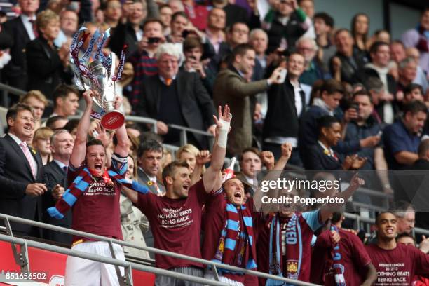 Kevin Nolan of West Ham lifts the Championship Playoff trophy after his team wins the npower Championship Playoff Final between West Ham United and...