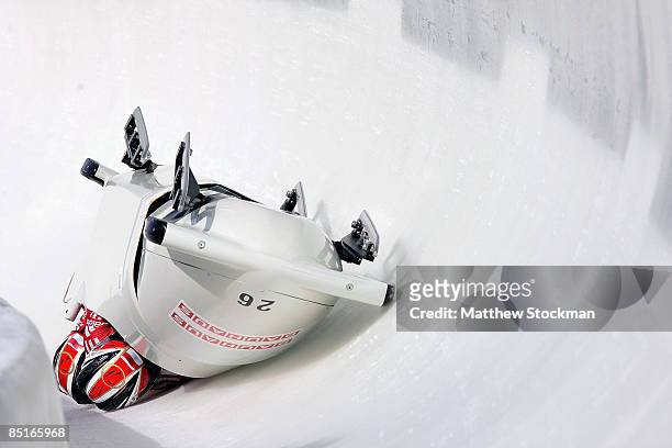 Monoco 1, piloted by Patrice Servelle, crashes in the third run of the the four man competition during the FIBT Bobsled World Championships at the...