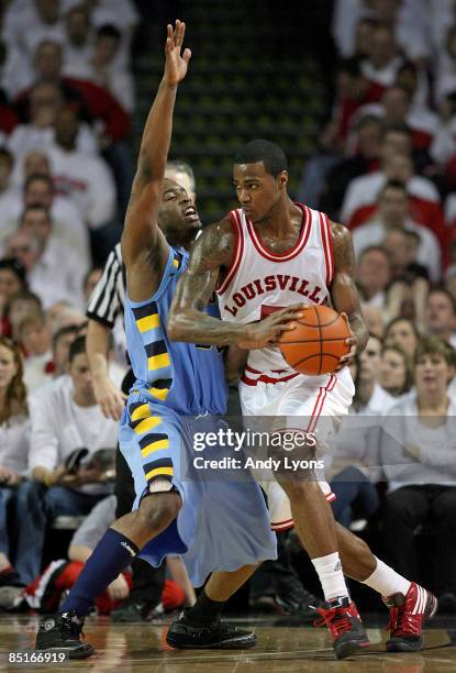 Earl Clark of the Louisville Cardinals dribbles the ball while defended by Wesley Matthews of the Marquette Golden Eagles during the Big East...