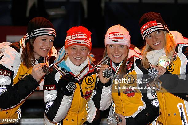 Germany team members Katrin Zeller, Stehle Evi Sachenbacher, Miriam Goessner and Claudia Nystad celebrate with their silver medals after the FIS...