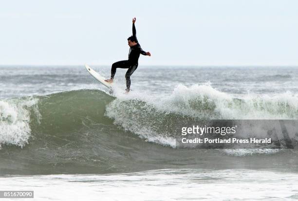Surfer catches air after riding over the crest of a wave on Wednesday at Higgins Beach. Tropical Storm Jose was stirring up big waves in Southern...