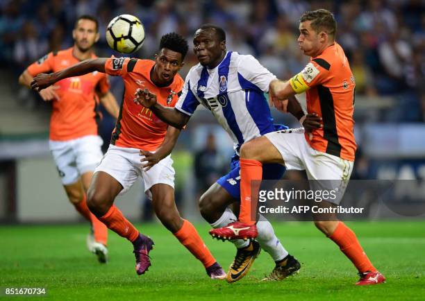 Porto's Cameroonian forward Vincent Aboubakar vies with Portimonense's Brazilian defender Felipe Macedo and defender Ricardo Pessoa during the...