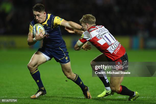 Josh Adams of Worcester Warriors holds off Ollie Thorley of Gloucester during the Aviva Premiership match between Gloucester Rugby and Worcester...
