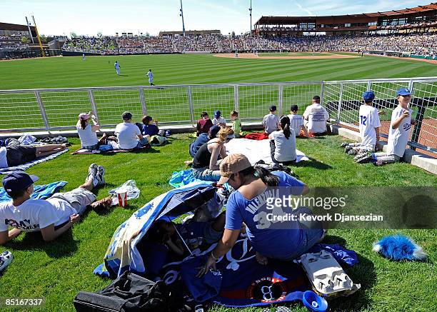 Fans in right field watch a spring training game of the Los Angeles Dodgers home opener against Chicago White Sox at Camelback Ranch March 1, 2009 in...