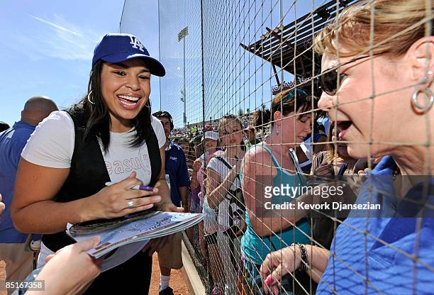 Jordin Sparks signs autographs after singing the national anthem during pre-game ceremonies for the Los Angeles Dodgers home opener against the...