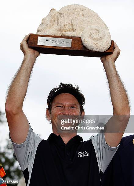 Mark Wilson celebrates with the winner's trophy after the final round of the Mayakoba Golf Classic on March 1, 2009 at El Camaleon Golf Club in...