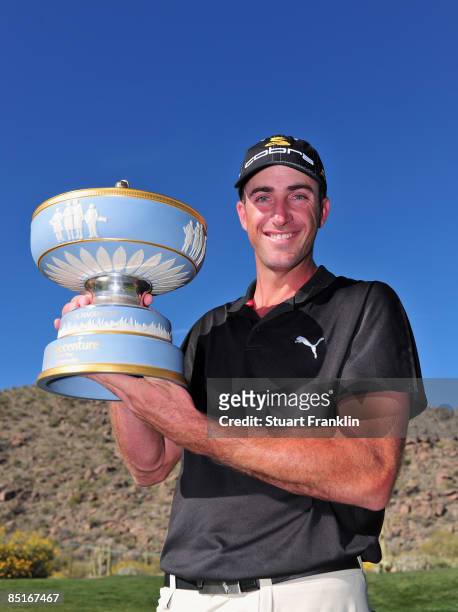 Geoff Ogilvy of Australia holds the trophy after winning his match against Paul Casey of England on the 16th hole during the final round of Accenture...