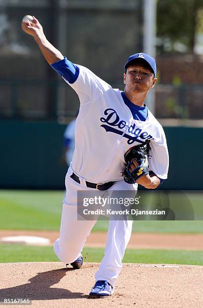 Hiroki Kuroda of the Los Angeles Dodgers throws a pitch as he warms up before the start of the Dodgers home opener spring training game against the...