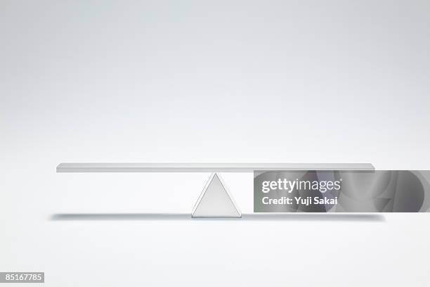 balanced seesaw - seesaw stock pictures, royalty-free photos & images