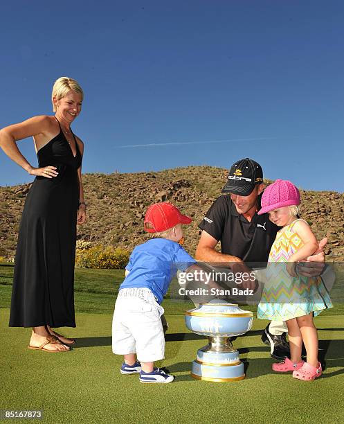 Geoff Ogilvy and family members wife Juli, son, Jasper, and daughter, Phobe, gather around the Walter Hagen Cup trophy after winning the final round...