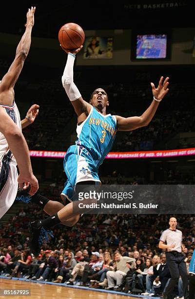 Chris Paul of the New Orleans Hornets shoots over Trenton Hassell of the New Jersey Nets on March 1, 2009 at the IZOD Center in East Rutherford, New...