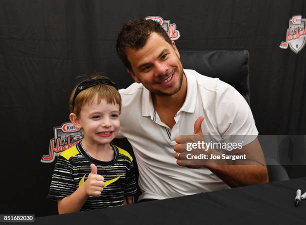 Fan takes a photo with former Pittsburgh Penguin Tyler Kennedy during Day 2 of NHL Kraft Hockeyville USA on September 22, 2017 in Belle Vernon,...