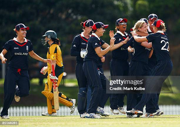 The England team congratulate Katherine Brunt after she took the wicket of Karen Rolton of Australia during the ICC Women's World Cup 2009 Warm Up...