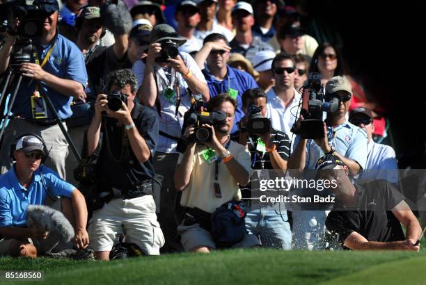 Geoff Ogilvy chips onto the 13th green during the final round of the World Golf Championships-Accenture Match Play Championship held at The...