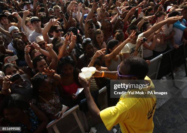 The crowd are given water by pit staff whilst watching Kendrick Lamar performing on the Main Stage at the Yahoo! Wireless Festival, at the Queen...