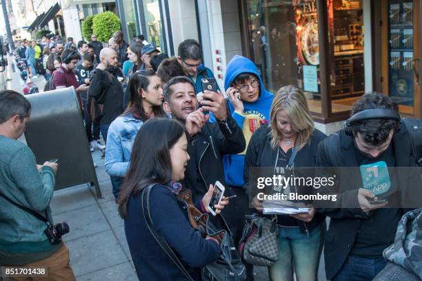 Customers stand in line during the sales launch of the Apple Inc. IPhone 8 smartphone, Apple watch series 3 device, and Apple TV 4K outside a store...