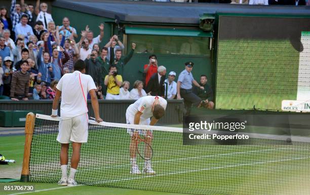 Andy Murray of Great Britain is congratulated by Jo-Wilfried Tsonga of France after winning the match to become Britain's first men's finalist since...