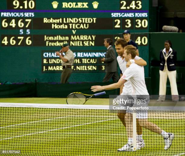 Jonathan Marray of Great Britain and Frederik Nielsen of Denmark celebrate after winning their Gentlemans Doubles final match against Robert...