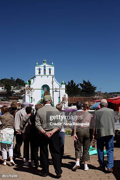 Tourists stand infront of the Templo de San Juan on November 26, 2008 in San Juan Chamula, Chiapas, Mexico. San Juan Chamula is a traditional Mexican...