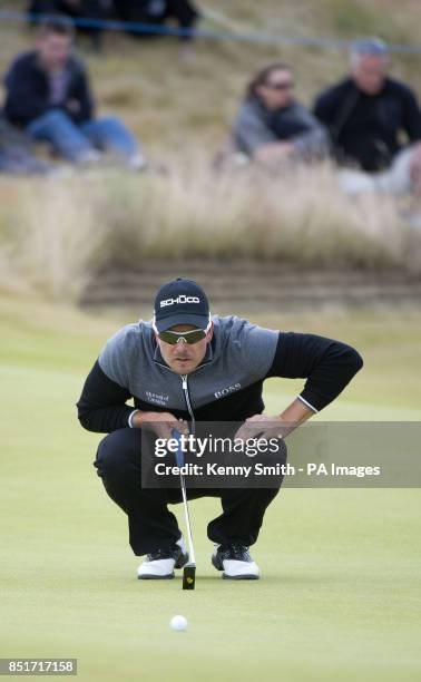 Henrik Stenson lines up his par putt on the 5th hole during day four of the Aberdeen Asset Management Scottish Open at Castle Stuart Golf Course,...