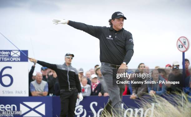 Phil Mickelson indicates that playing partner Henrik Stenson's ball has gone wide right during day four of the Aberdeen Asset Management Scottish...