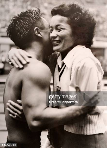 Sammy Lee of the USA, winner of the men's 10 metre platform diving event, is congratulated by teammate Vicki Draves , winner of the women's 3 metre...