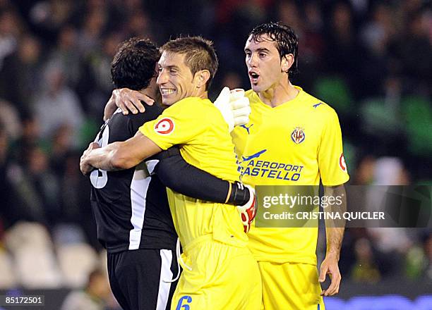 Villarreal's goalkeeper Diego López celebrates with teammate Jose Joaquin Moreno and Diego Godin after teammate Santiago Cazorla scored Villareal's...