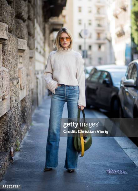 Lisa Hahnbueck wearing Golden Goose deluxe brand turtle neck, Citizens of Humanity jeans, MCM bag, MCM Charm, Balenciaga boots is seen during Milan...