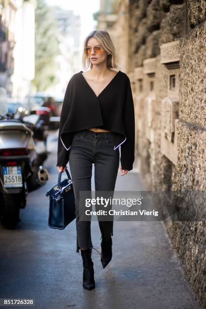 Lisa Hahnbueck wearing Diane von Furstenberg jacket, Mother Denim copped jeans, Dior ankle boots, Fendi peekaboo bag is seen during Milan Fashion...