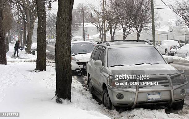Woman shovels snow from a sidewalk March 2, 2009 in the Bronx Borough of New York City. Heavy snows created choas around the northeast United States....