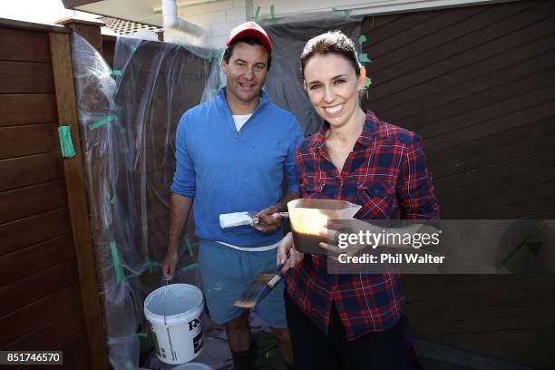 Labour party leader Jacinda Ardern and her partner Clarke Gayford pose as they paint the fence of their Pt Chevelier house on September 23, 2017 in...