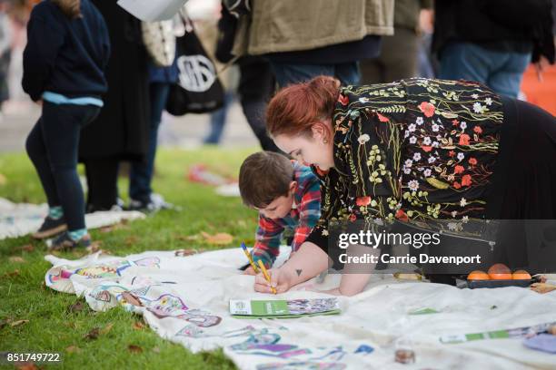 Young boy and his mum drawing at The Big Picnic at Culture Night Belfast on September 22, 2017 in Belfast, Northern Ireland.