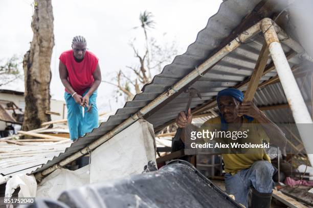 Residents dismantle a roof days after Hurricane Maria made landfall, on September 22, 2017 in Loiza, Puerto Rico. Many on the island have lost power,...