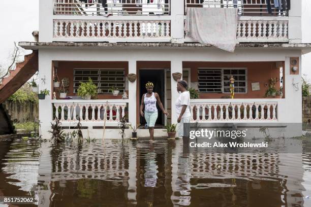 Residents wade through flood waters at their home days after Hurricane Maria made landfall, on September 22, 2017 in Loiza, Puerto Rico. Many on the...