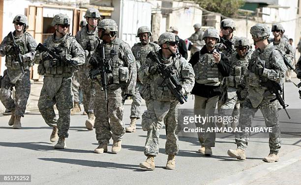 Soldiers patrol the streets during the transfer of authority of the Shulla Joint Security Station from the US military LTC Vermeesch to the 2nd...