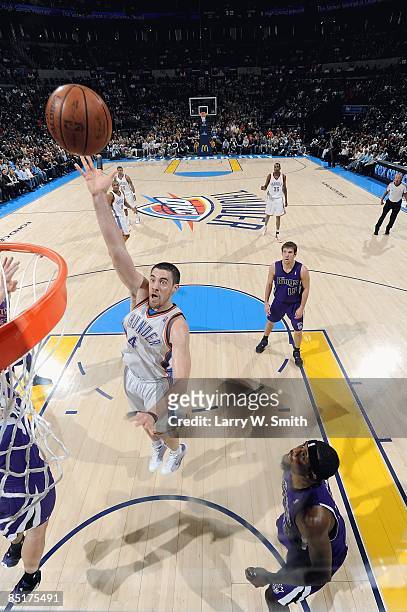 Nick Collison of the Oklahoma City Thunder puts up a shot against John Salmons of the Sacramento Kings during the game on February 8, 2009 at the...