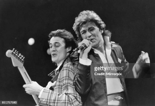 George Michael and Andrew Ridgley of pop duo Wham! performing on stage, 5th December 1984.