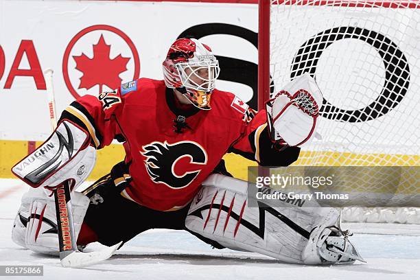 Miikka Kiprusoff of the Calgary Flames makes a glove save against the Columbus Blue Jackets on February 24, 2009 at Pengrowth Saddledome in Calgary,...